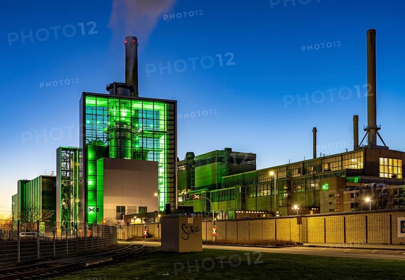 The Lausward combined heat and power plant in Düsseldorf, gas and steam turbine power plant, operated by Stadtwerke Düsseldorf and EnBW, in the harbour of Düsseldorf on the Rhine, green illuminated city window, the chimney of the Fortuna power plant unit, the power plant generates electricity, also traction current and district heating, North Rhine-Westphalia, Germany, Europe
