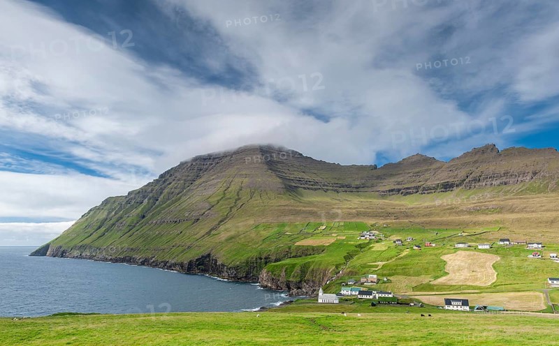 Coastal landscape with mountains and village under blue sky, Vidareidi, Vidoy Island, Viðareiði, Viðoy Island, Faroe Islands, Denmark, Europe