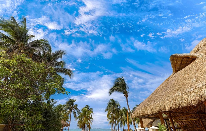 Serene turquoise Isla Mujeres beach Playa Norte famous for emerald waters, sandy sea shore and beach bars for fun and beach parties.