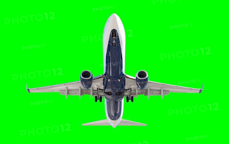 Passenger airplane either taking off or landing over a green screen