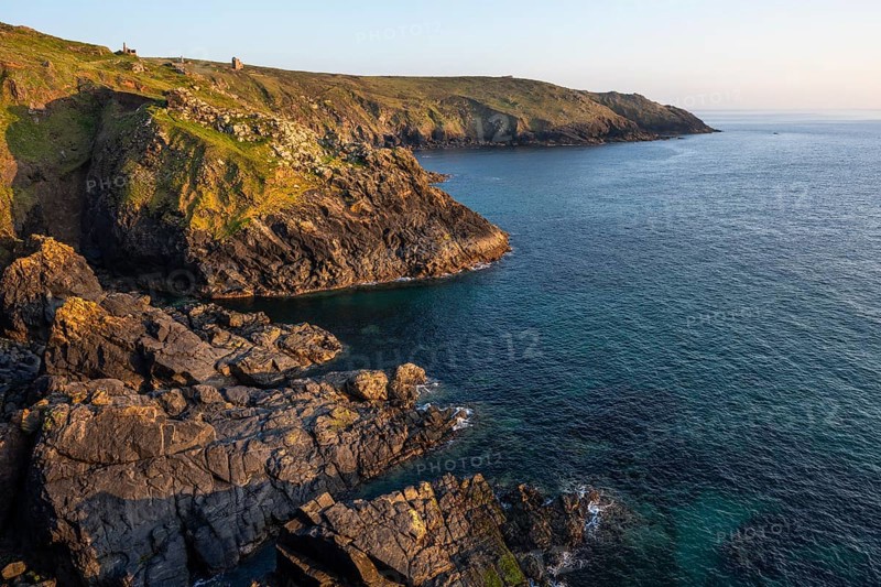 Coastal landscape at Botallack Mine, also known as Crown Mine. The ruins of Wheal Edward in the background. Evening, golden hour. Botallack, Penzance, Cornwall, England, Great Britain
