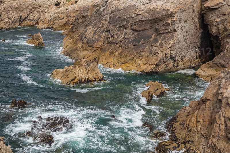 Rocky west coast of the Quiberon peninsula in Brittany, France. Crashing waves and rocks