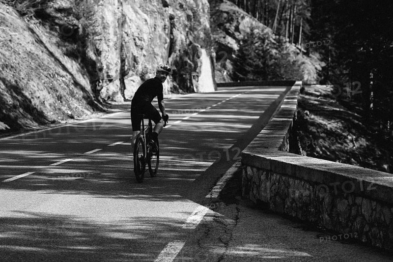 Road bike rider in spring between Lechtal and Tannheimer Tal in front of picturesque scenery of the Alps, Tyrol, Austria, Europe