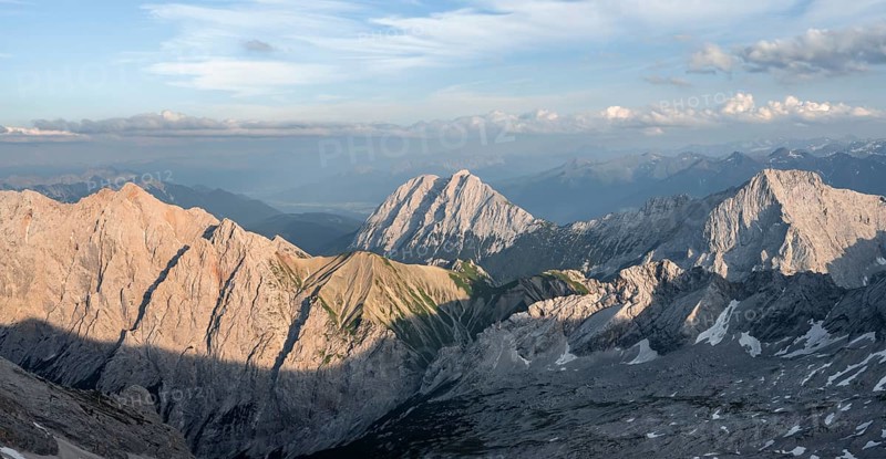 Impressive rocky mountain landscape in the evening light, view from the summit of the Zugspitze to Hohe Munde and Mieminger Kette, Wetterstein range, Bavaria, Germany, Europe