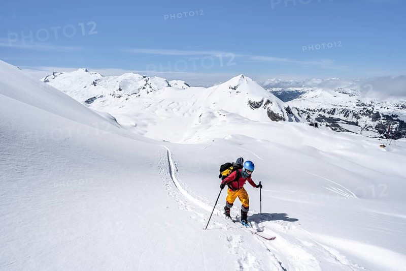 Ski tourer in mountain landscape with snow, behind summit Mittaghorn and Wildhorn, ascent to Wildstrubelhütte, Bernese Alps, Switzerland, Europe
