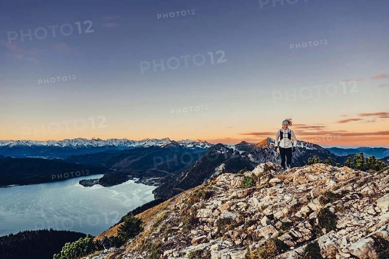 Trail running in autumn on the Jochberg on Lake Walchensee against the wonderful backdrop of the Alps, Bavaria, Germany, Europe