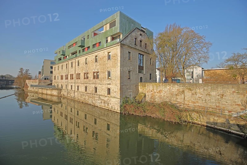 Historic Karlshospital built in 1721 and former penitentiary on the river Fulda, baroque, modern and old building, extension 2008, roof, verdigris, reflection, stone wall, Kassel, Hesse, Germany, Europe