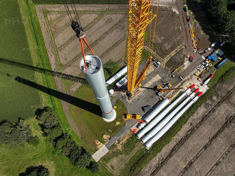 Dorsten, North Rhine-Westphalia, Germany, construction of a wind turbine, the first wind turbine of the Grosse Heide wind farm. The rotor blades are ready for assembly. A large mobile crane places the tower elements, the rings, on top of each other. This wind turbine will have a rated output of 5, 500 kW, Europe