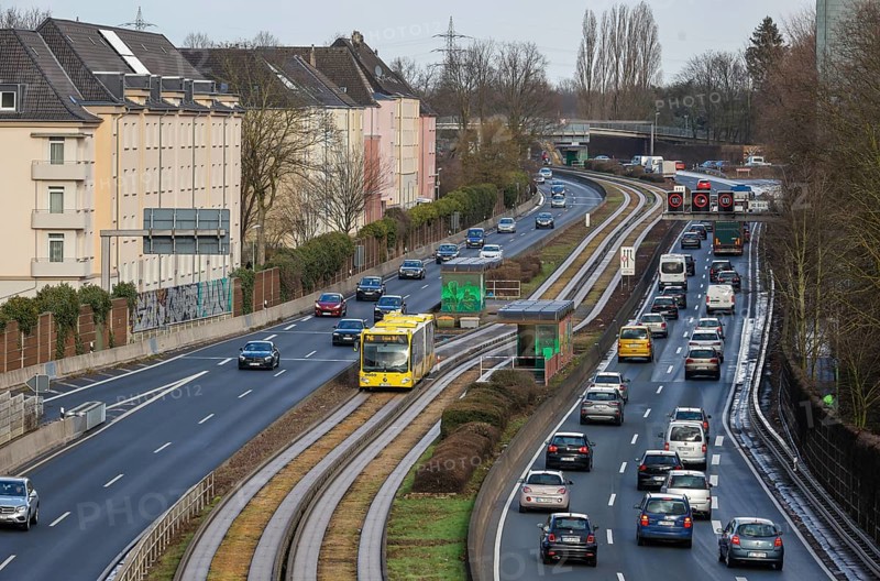 Essen, North Rhine-Westphalia, Germany - Cars and a public bus drive through Essen city centre on the A40 motorway