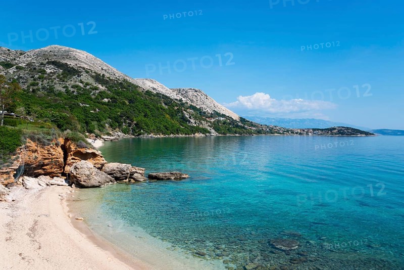 Clear blue sea water on a sandy beach with rocky coastline under a cloudless sky, bay near Stara Baška, Stara Baska, Altweschke, Primorje-Gorski kotar, Croatia, Europe