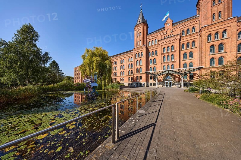 New town hall, brick architecture, architectural style neo-gothic, park, trees, footpath, pond, metal railing, blue sky, cloudless, street Am Französischen Garten, Celle, Lüneburger Heide, district Celle, Lower Saxony, Germany, Europe