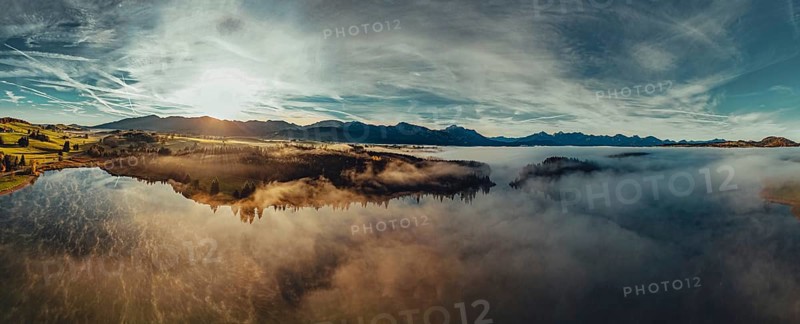 Autumn sunrise in the foothills of the Alps with fog at Illasbergsee and Forggensee near Halblech in Allgäu, Bavaria, Germany, Europe