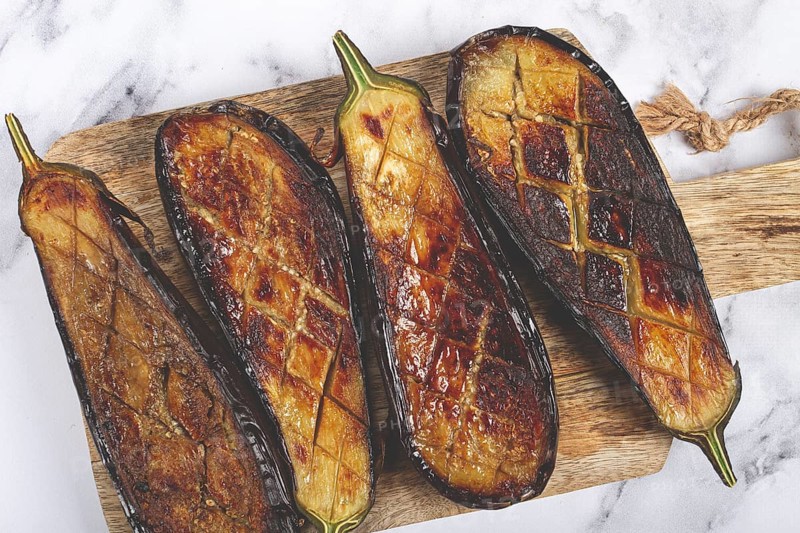 Sliced fried eggplant, on a chopping board, top view, homemade, no people