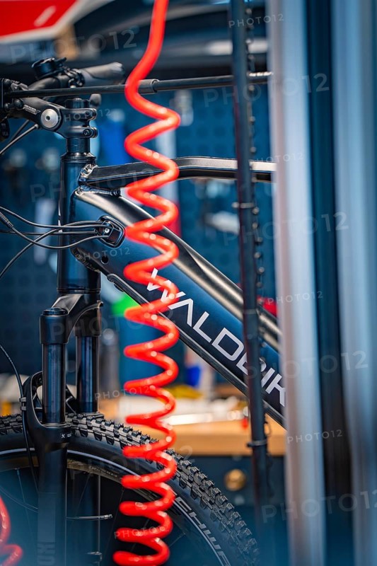 Close-up of a bicycle with a red inner tube in a workshop environment, focus on technology, Waldbike Manufaktur, bicycle workshop, Calw, district of Calw, Black Forest, Germany, Europe