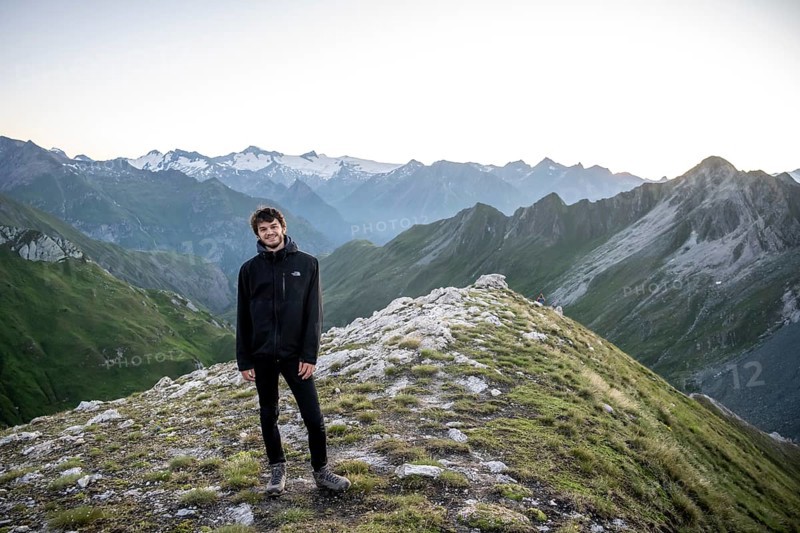 Hiker enjoying the mountain panorama in the morning, Venediger group, behind Dreiherrenkopf, Simonysitze and Großer Geiger, Hohen Tauern, Austria, Europe