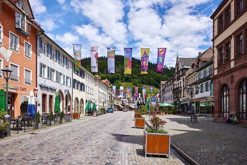 Historic buildings, old town, flower tubs, cobblestones, town festival, flags for the town anniversary, main street, Wolfach, Black Forest, Ortenaukreis, Baden-Württemberg, Germany, Europe