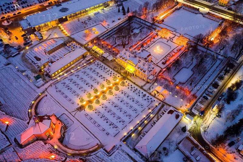 Aerial view of Wackerbarth Castle with castle park, belvedere and vineyards with snow and Christmas lights, Radebeul, Saxony, Germany, Europe
