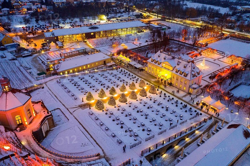Aerial view of Wackerbarth Castle with castle park, belvedere and vineyards with snow and Christmas lights, Radebeul, Saxony, Germany, Europe