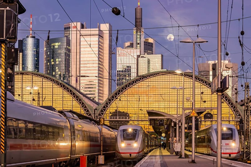 Frankfurt main station with ICE train in the evening, full moon and sunset. View of platform and banking district, skyline of Frankfurt am Main, Hesse, Germany, Europe