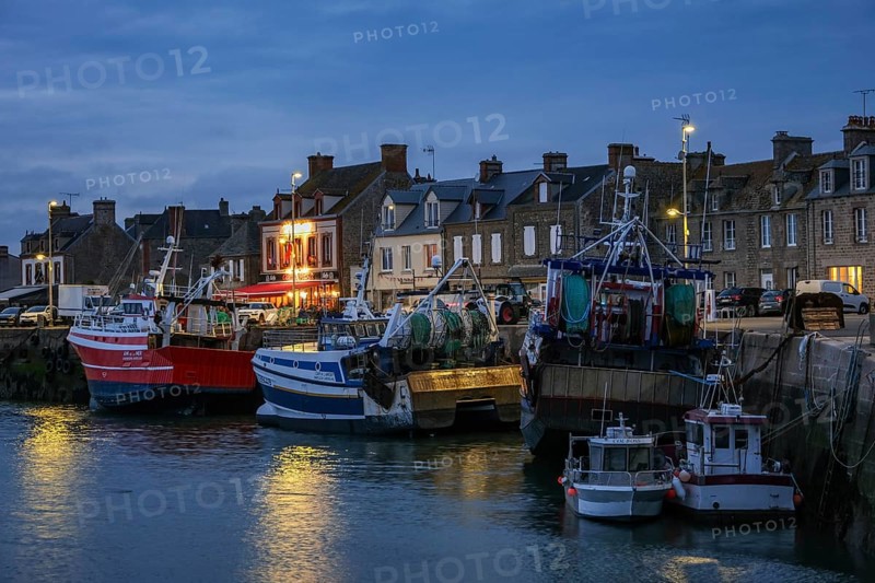 Barfleur, Normandy, France - Fishing boats on the quay in the harbour of Barfleur, a picturesque fishing village, a French commune in the Manche department on the Cotentin peninsula in the Normandy region, behind the famous Café de France