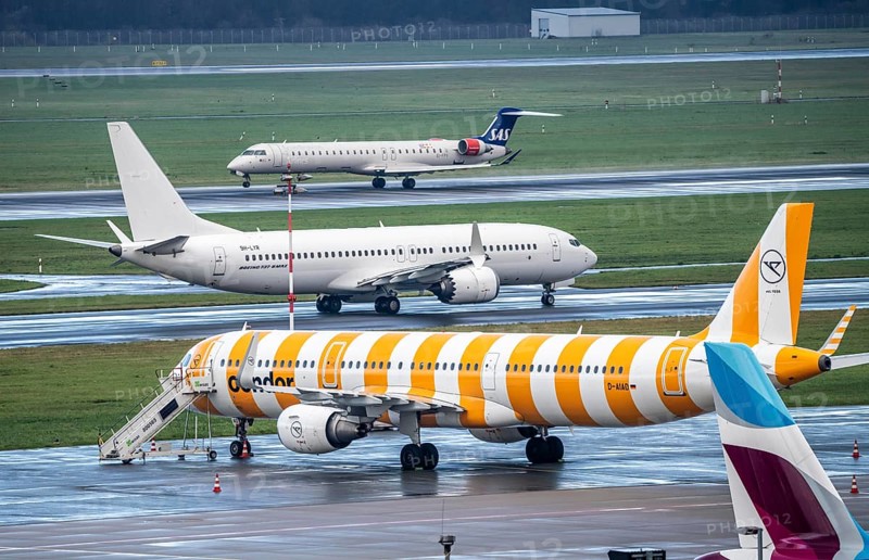 Düsseldorf Airport, Eurowings, Condor aircraft on the apron, SAS Mitsubishi CRJ-900LR on take-off, Boeing 737 MAX 8 of SmartLynx Airline on the taxiway for take-off, Düsseldorf, North Rhine-Westphalia, Germany, Europe