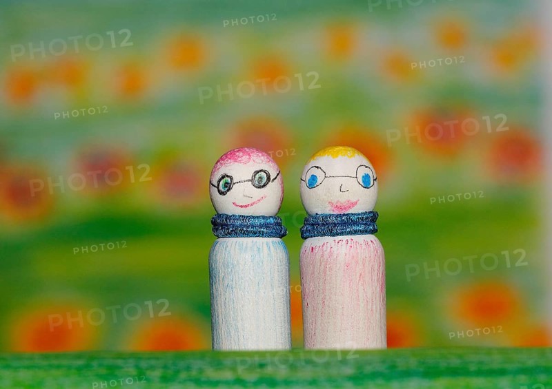 Two small funny wooden cones in front of a painted background, North Rhine-Westphalia, Germany, Europe