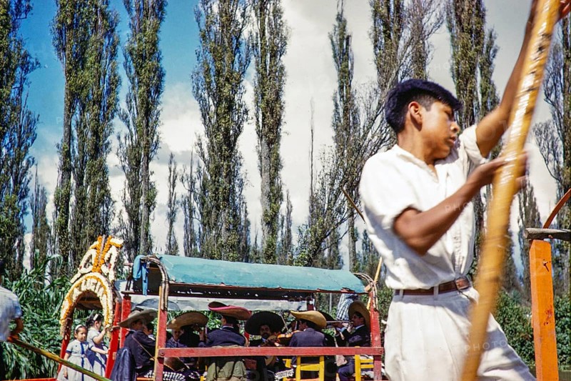 People staking out on boats on the canalas in Xochimilco, Ciudad de México, Mexico City, CDMX, Mexico around 1961