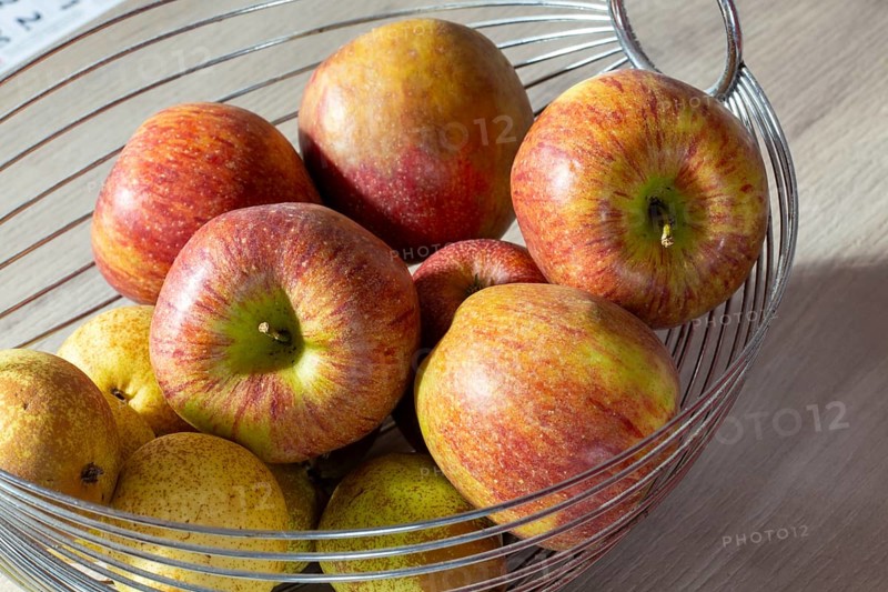 Close-up of apples and pears in the fruit basket