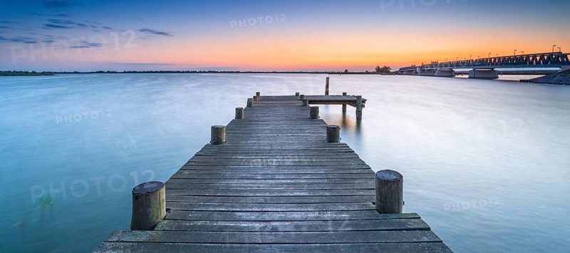 Jetty on the Peene River at sunset, behind the bascule bridge to the island of Usedom, Mecklenburg-Western Pomerania, Germany, Europe