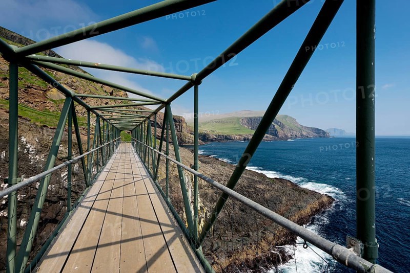 So-called Atlantic Bridge, pedestrian bridge over rock crevice Hólmgjógv, Mykines, Útoyggjar, Faroe Islands, Denmark, Europe