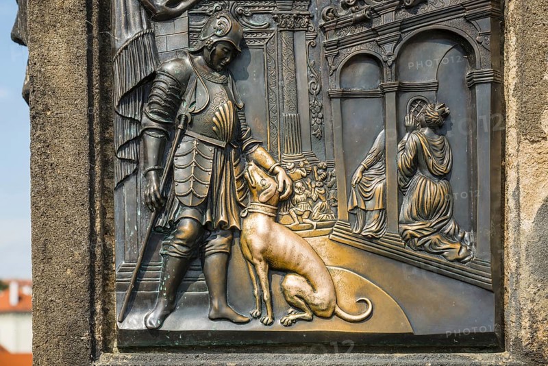 Bronze relief of a nobleman with a dog, laying hands on the relief of the dog is said to bring good luck, statue of St John Nepomuk, Charles Bridge, Prague, Bohemia, Czech Republic, Europe