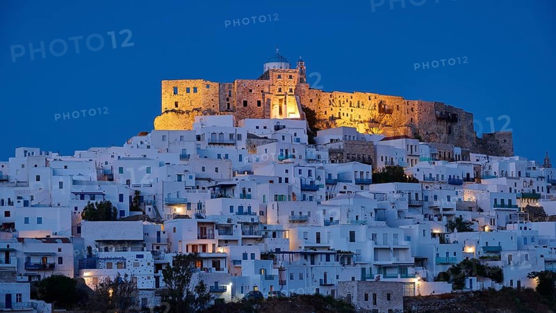 Night view of an illuminated castle above white houses with blue evening lighting, Querini Castle, Chora, Astypalea, Dodecanese, Greek Islands, Greece, Europe
