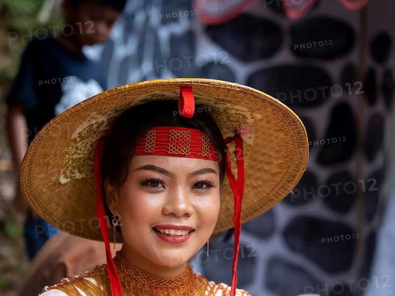 Toraja woman in traditional colourful clothes with rice straw hat, smiling, portrait, Tana Toraja, Rantepao, Sulawesi, Indonesia, Asia