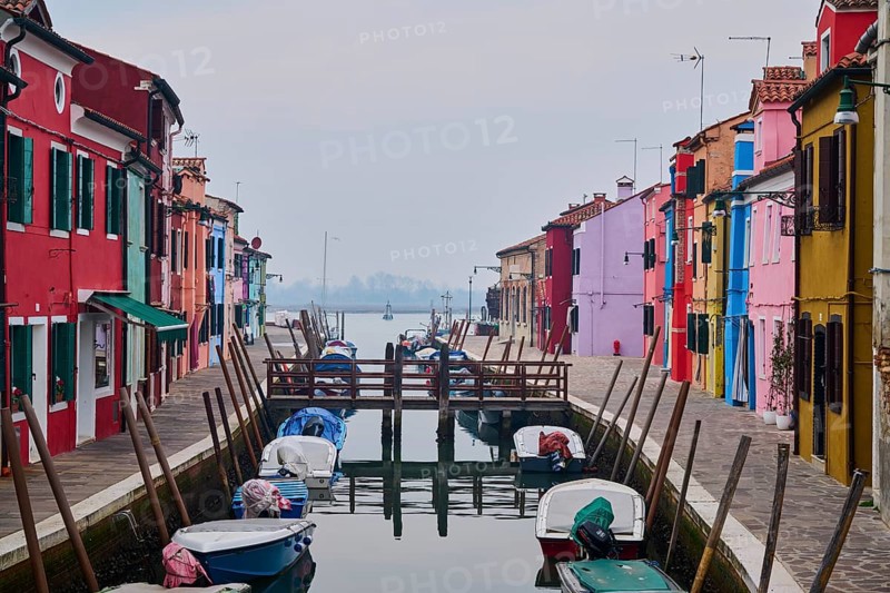 Colorful houses beside the waterway in between 'Fondamenta Cao di Rio a Sinistra' and 'Fondamenta Cao di Rio a Destra' with boats lying in the water on the island of Burano, Italy, Europe