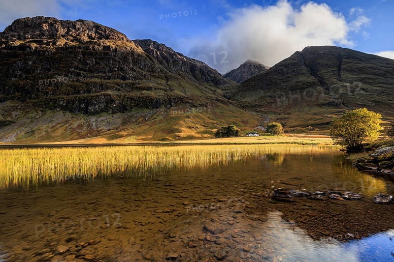 Mountains reflected in loch, evening light, cloudy mood, Achnambeithach Cottage, Loch Achtriochtan, Glencoe, Scottish Highlands, Scotland, Great Britain