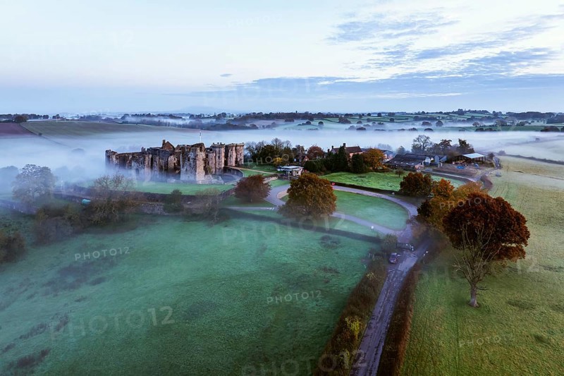 Raglan Castle in the fog at dawn from a drone, Monmouthshire, Wales, England, United Kingdom, Europe