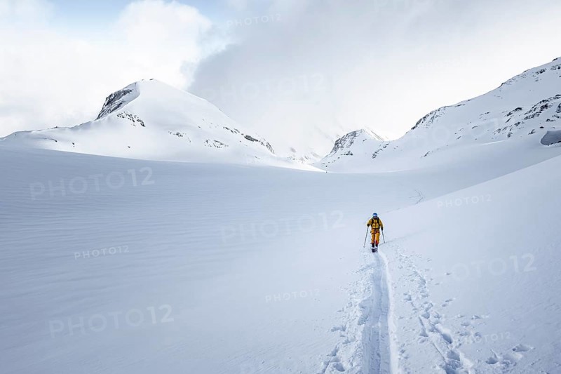 Lone ski tourer in snowy mountain landscape, ascent to the Wildhorn, cloudy mood, high tour, Bernese Alps, Bernese Oberland, Switzerland, Europe