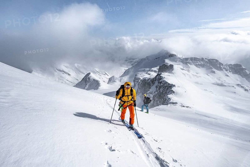 Ski tourers climbing the Wildhorn, Snowy mountain landscape and fog, Bernese Alps, Bernese Oberland, Switzerland, Europe