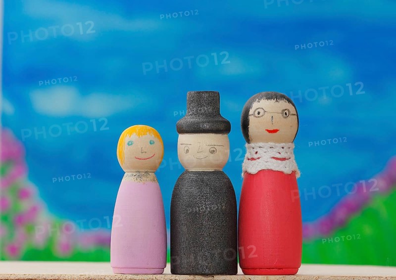 Three funny painted wooden cones in front of a painted background, North Rhine-Westphalia, Germany, Europe