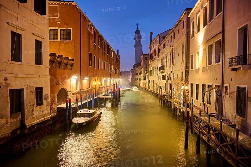View from the bridge 'Riva degli schiavoni' over to the church 'Chiesa di San Giorgio dei Greci' at the blue hour in the evening in Venice in winter, Italy, Europe