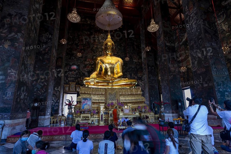 Golden Buddha statue, Phra Si Sakyamuni, (from the Sukhothai era and one of the largest seated Buddha statues in Thailand) surrounded by exquisite murals, interior view of the Vihara, Wat Suthat Thepwararam, Royal Temple, Phra Nakhon, Bangkok, Thailand, Asia