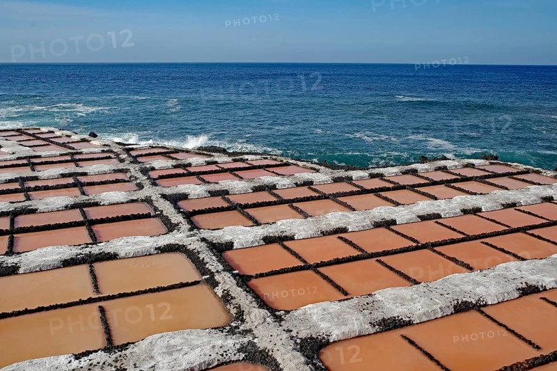 Regular arrangement of salt fields in orange near the blue sea under a clear sky, salt flats, Fuencialente, La Palma, Canary Islands, Spain, Europe