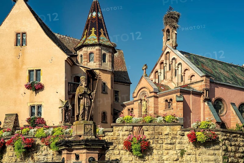 Fountain Fontaine de Saint-Léon and St Leo's Chapel in Eguisheim, Alsace, France, Europe