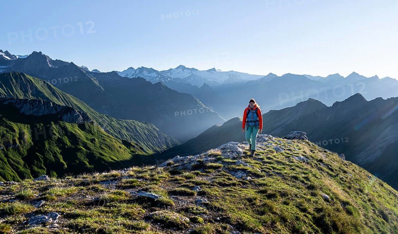Hiker enjoying the mountain panorama in the morning, Venediger group, behind Dreiherrenkopf, Simonysitze and Großer Geiger, Hohen Tauern, Austria, Europe