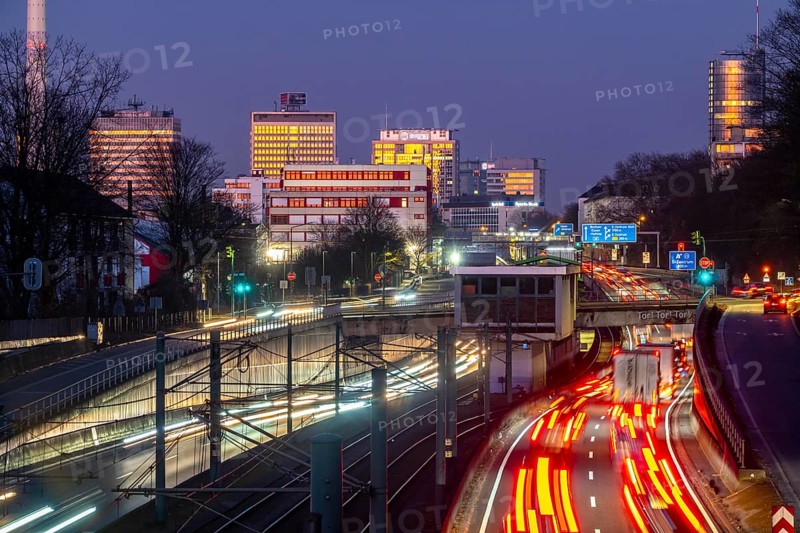 Motorway A40, Ruhr expressway, heavy traffic jam, rush hour, city passage in Essen, skyline of the city centre, underground line between the lanes, Hobeisenbrücke stop, North Rhine-Westphalia, Germany, Europe