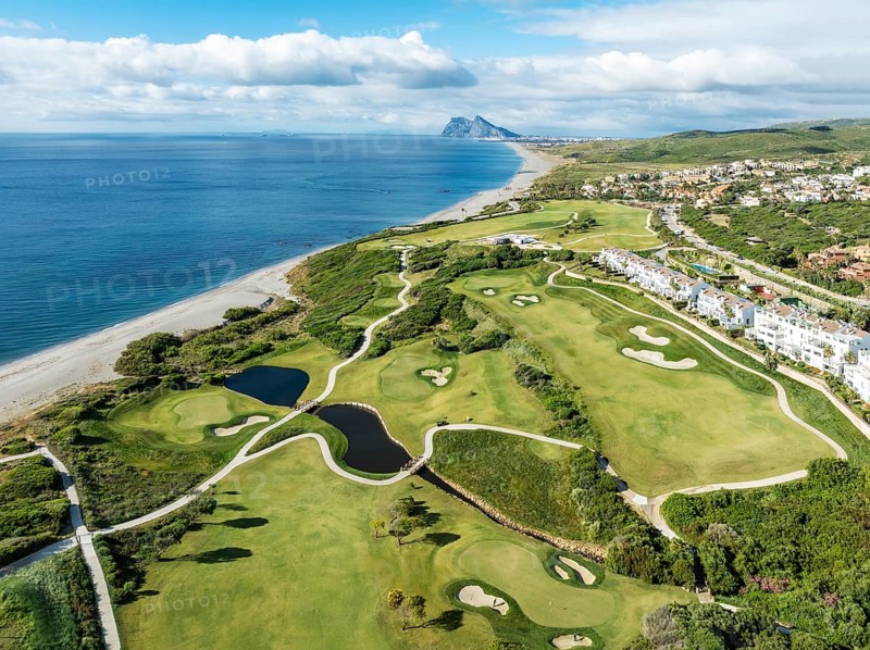 The La Hacienda Links Golf Resort at the Mediterranean Sea with the Rock of Gibraltar (British) in the distance. Aerial view. Drone shot. Cádiz province, Andalusia, Spain, Europe