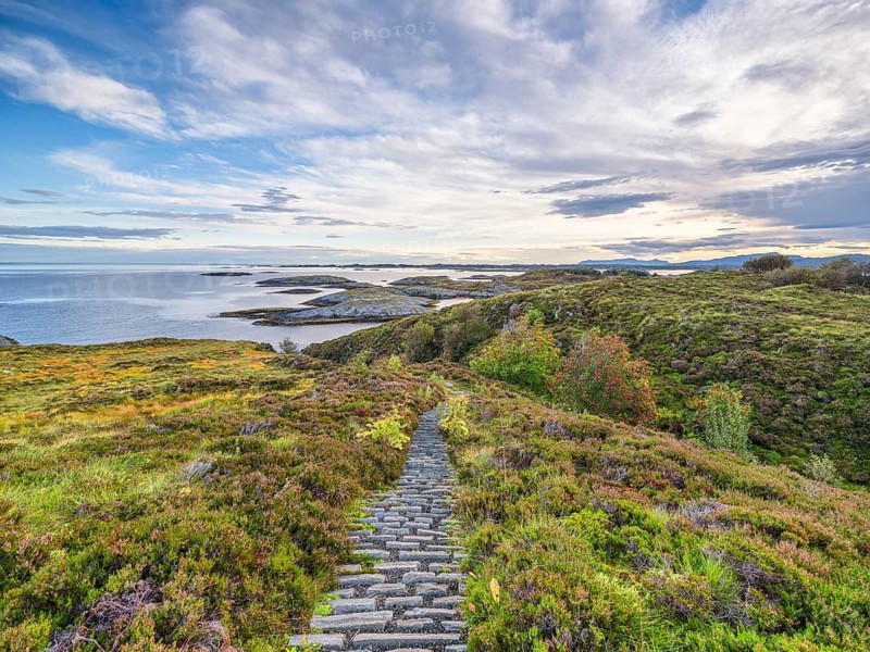 Hiking trail with a view of the sea along the Atlantic Road, blue sky with clouds, Atlanterhavsveien, Møre og Romsdal, Norway, Europe