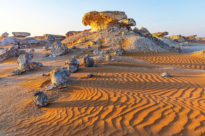 Striking cliffs surrounded by windswept sand structures, Huqf stone desert, Arabian Peninsula, Sultanate of Oman