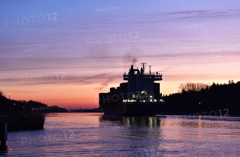 Container ship OOCL RAUMA at the blue hour, sunrise in the Kiel Canal, NOK, Kiel Canal, Schleswig-Holstein, Germany, Europe