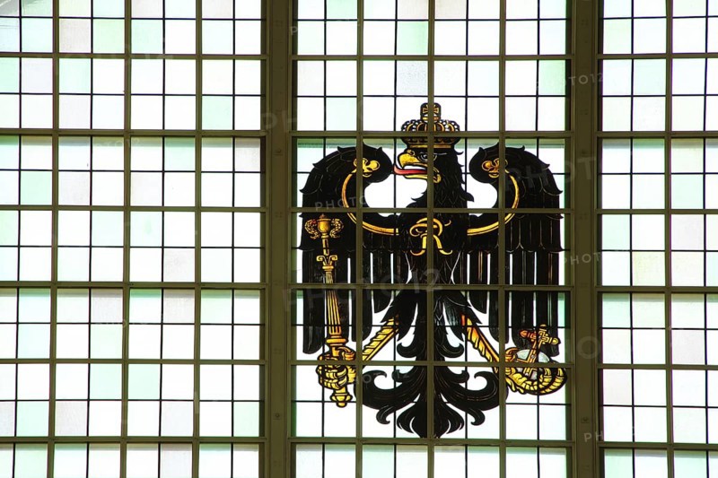 Stained glass window with German imperial eagle, national coat of arms, crown, black, craftsmanship, stained glass, interior view, vestibule, railway station, Bad Homburg, Taunus, Hesse, Germany, Europe